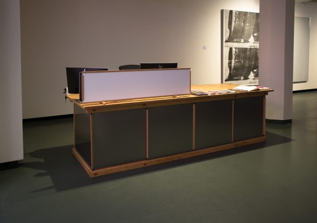 large museum reception desk with four sliding stainless steel doors overview